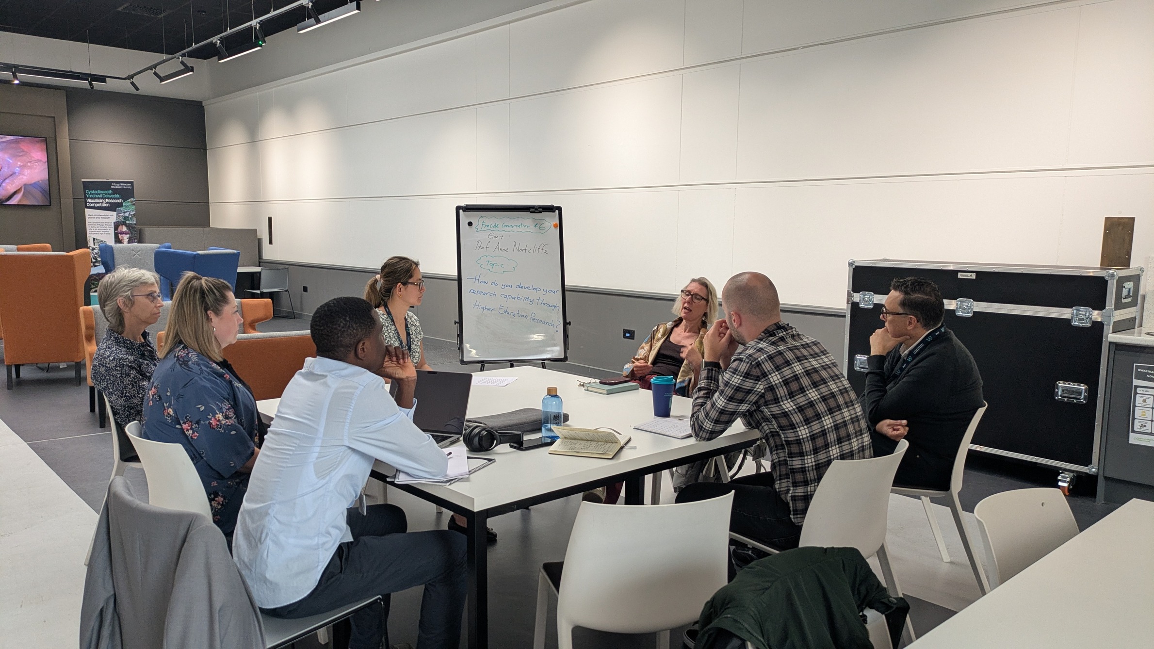 Group of people sat at a table in discussion