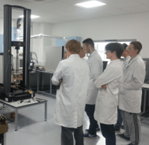 Students in a lab observing impact tower equipment