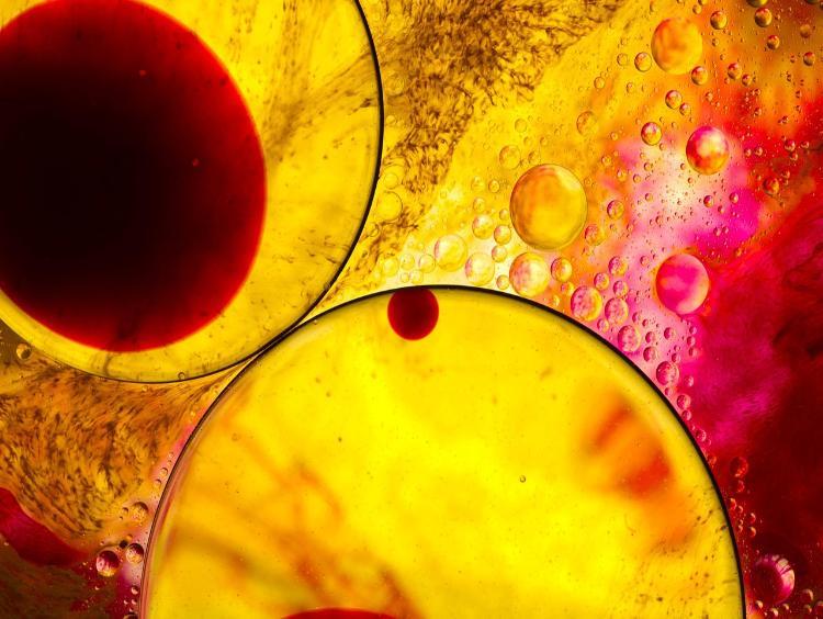 Water molecules closeup in a yellow colour