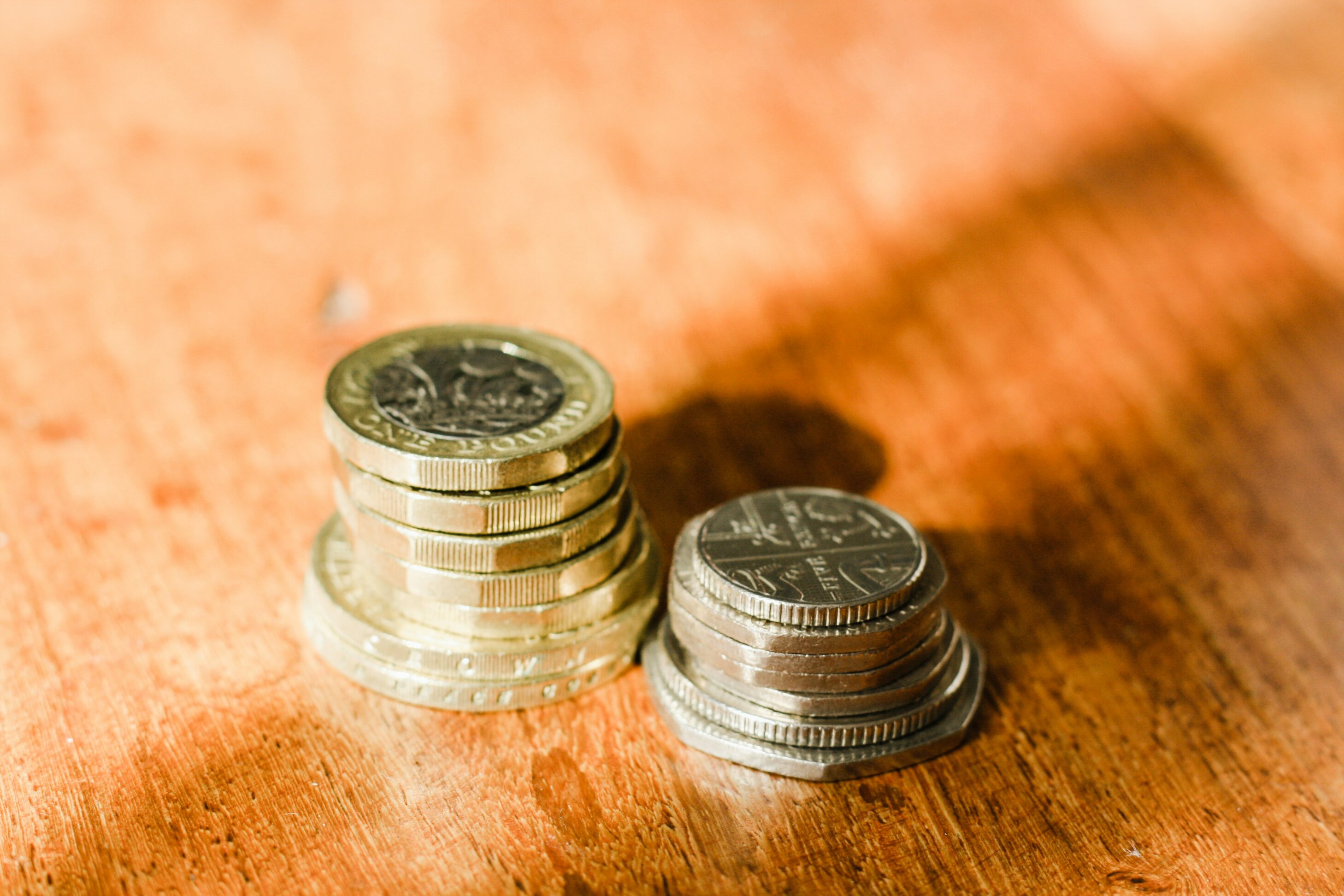 pound coins and British legal tender stacked