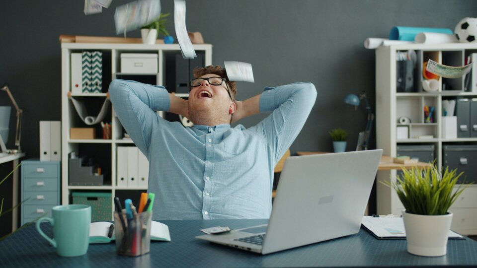 person leaning back in their chair happy