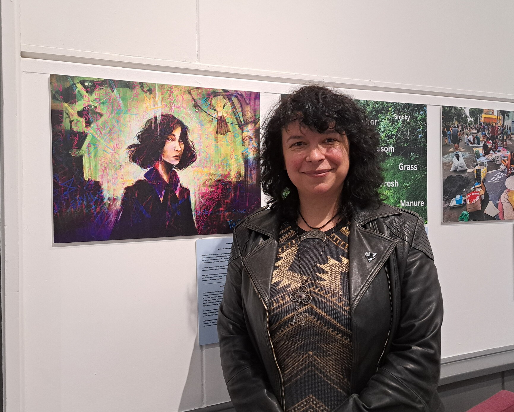 karolina standing next to their image on the wall