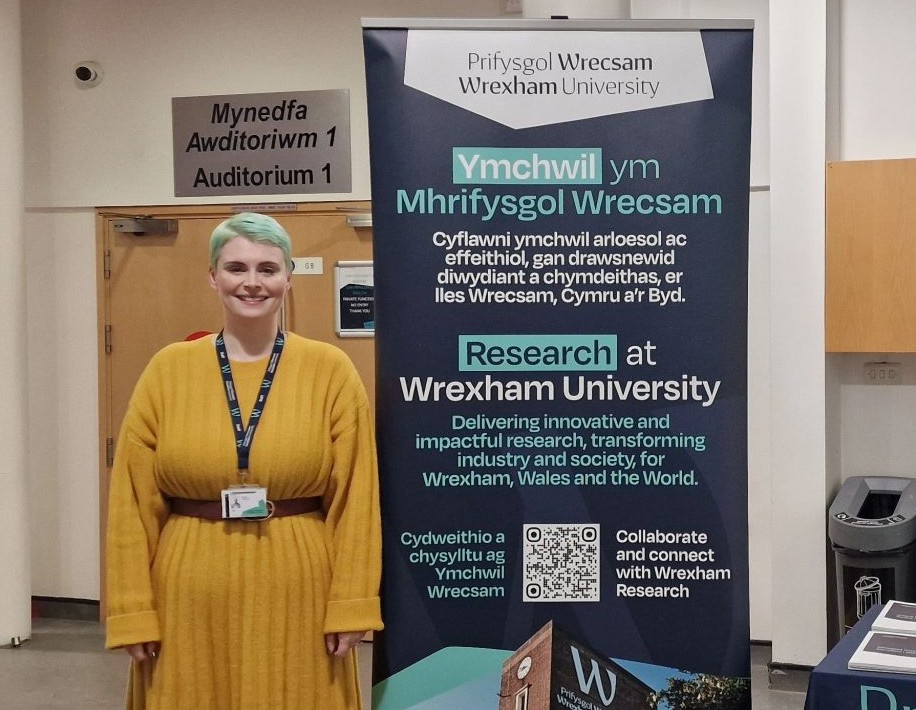 grace standing in front of a banner