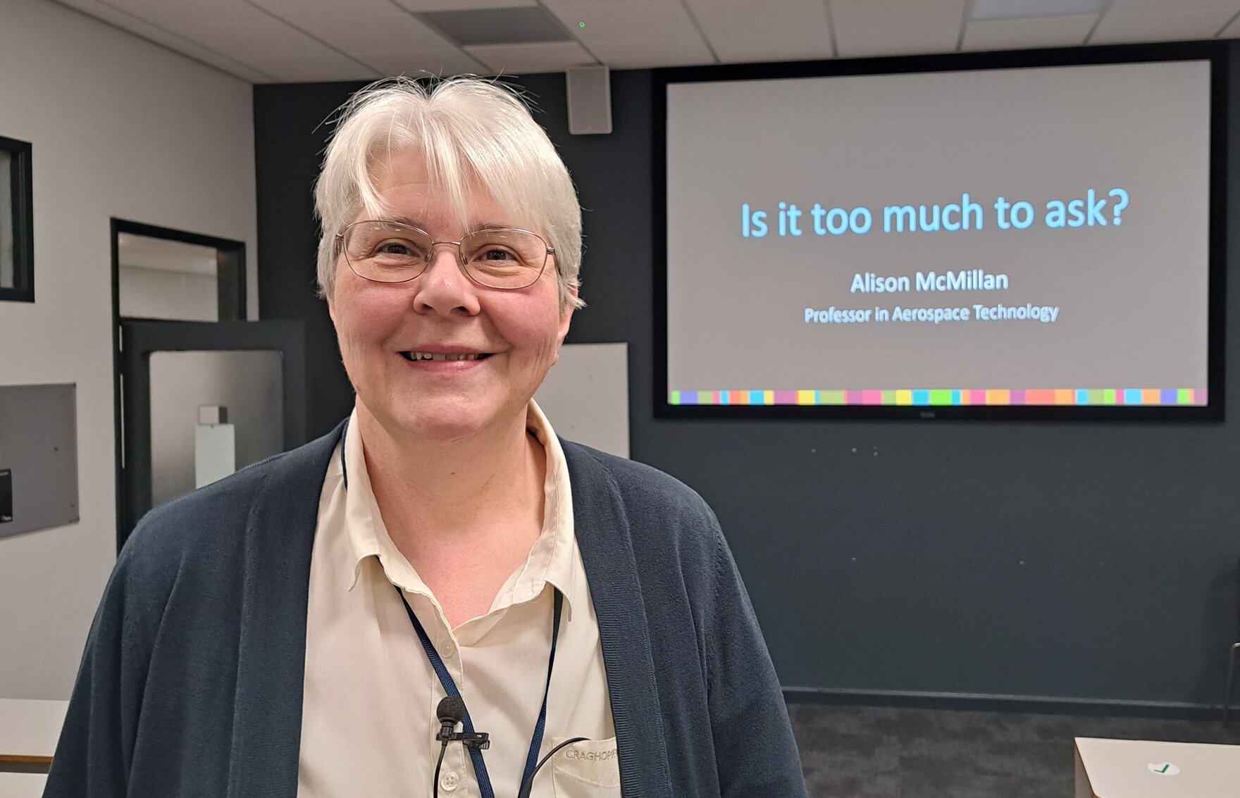 Alison standing in front of the screen of her talk