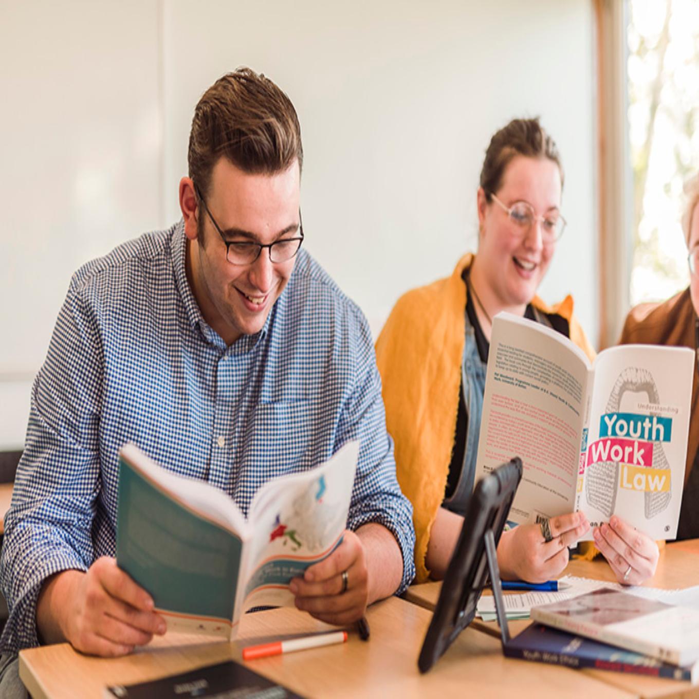 youth work students with books