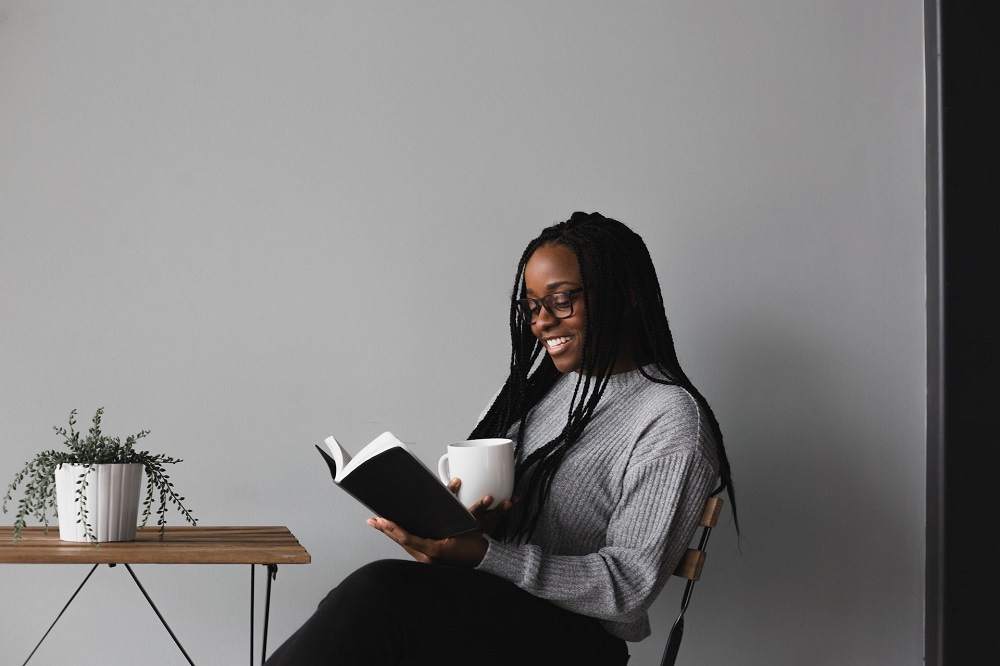 girl reading book and drinking coffee