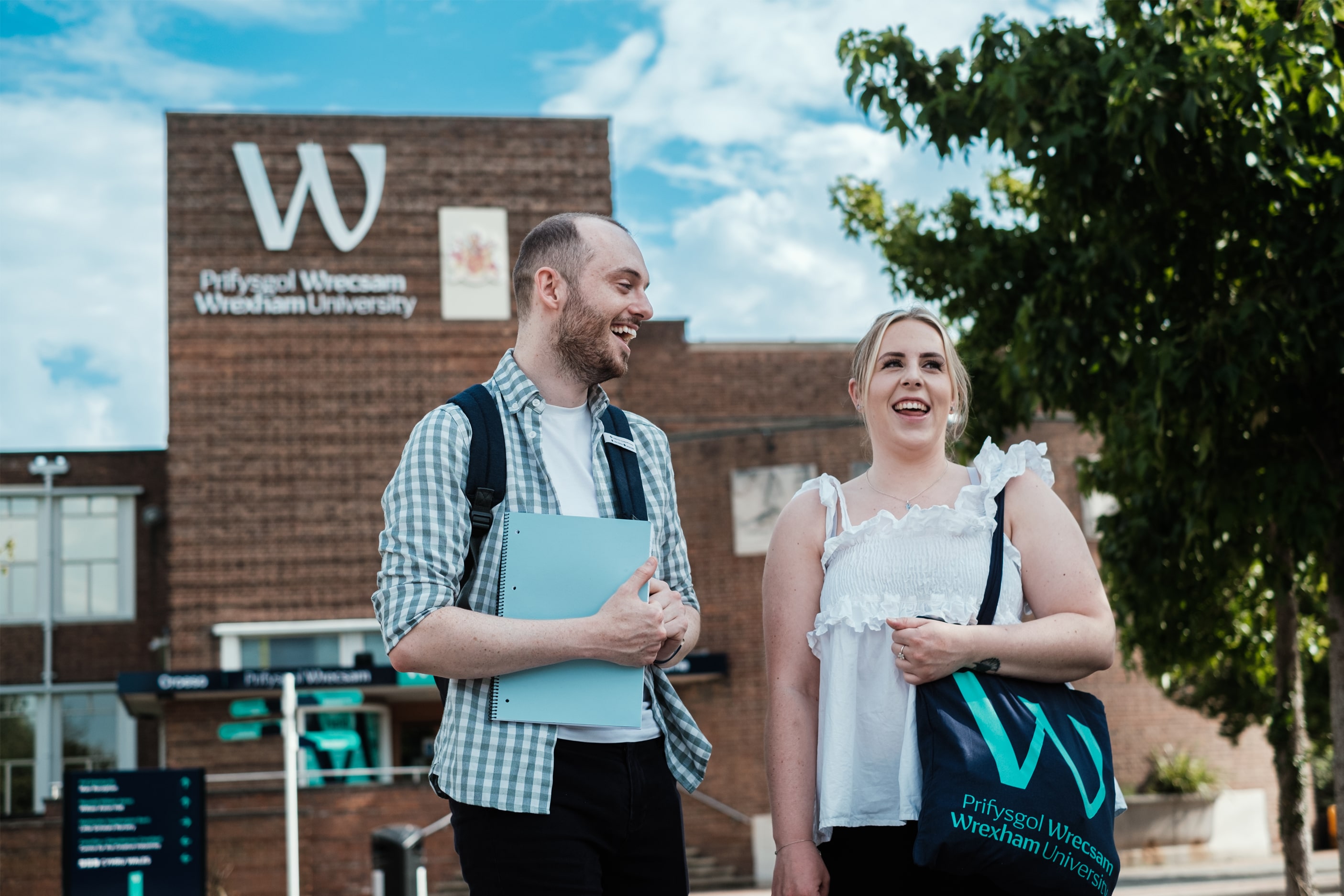 Students in front of Wrexham University clock tower